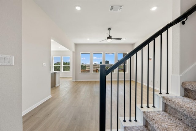 stairs featuring ceiling fan, wood finished floors, visible vents, and recessed lighting
