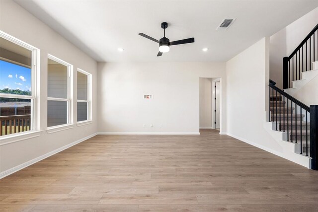 spare room with light wood-type flooring, a ceiling fan, recessed lighting, and stairs