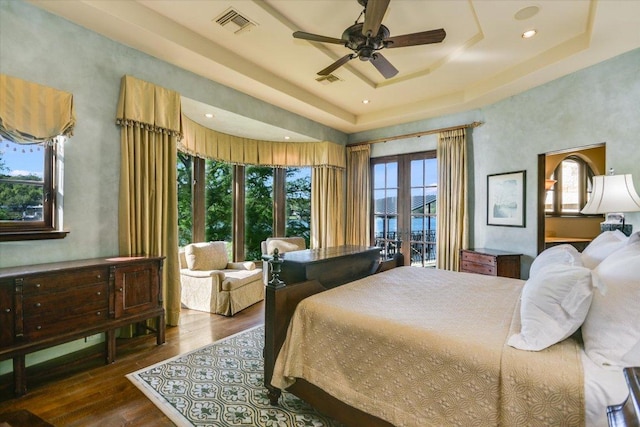 6704 Pixie Cv, Austin, TX 78746 - bedroom featuring a tray ceiling, wood finished floors, ceiling fan, and recessed lighting