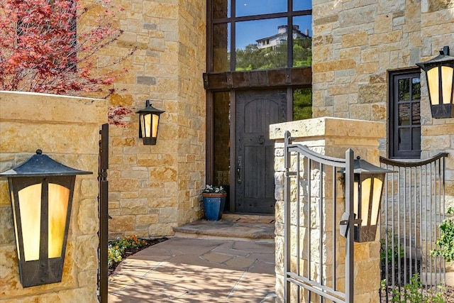 6704 Pixie Cv, Austin, TX 78746 - entrance to property with stone siding and a gate