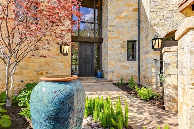 6704 Pixie Cv, Austin, TX 78746 - property entrance featuring stone siding and a gate