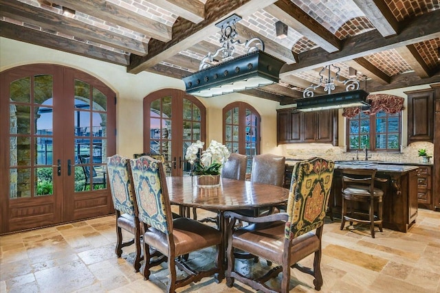6704 Pixie Cv, Austin, TX 78746 - dining room with french doors, stone tile flooring, beam ceiling, arched walkways, and brick ceiling
