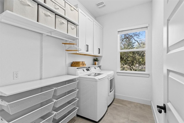 130 Volterra Ln, Dripping Springs, TX 78620 - laundry room with washer and dryer, cabinet space, and light tile patterned floors