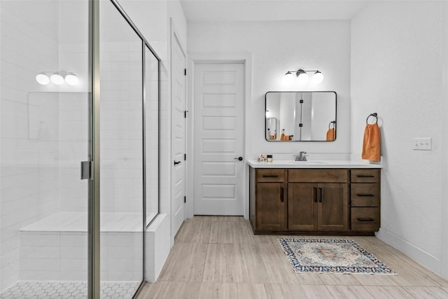 130 Volterra Ln, Dripping Springs, TX 78620 - full bathroom featuring vanity, a stall shower, and wood finished floors