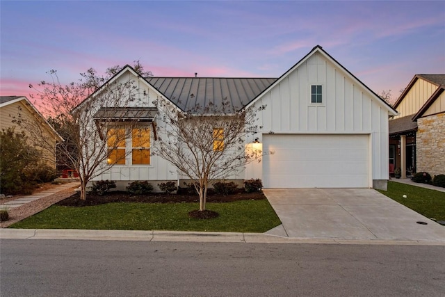130 Volterra Ln, Dripping Springs, TX 78620 - modern farmhouse with board and batten siding, concrete driveway, a lawn, a standing seam roof, and a metal roof