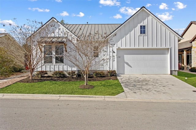 130 Volterra Ln, Dripping Springs, TX 78620 - view of front of home with a standing seam roof, board and batten siding, driveway, and a front lawn