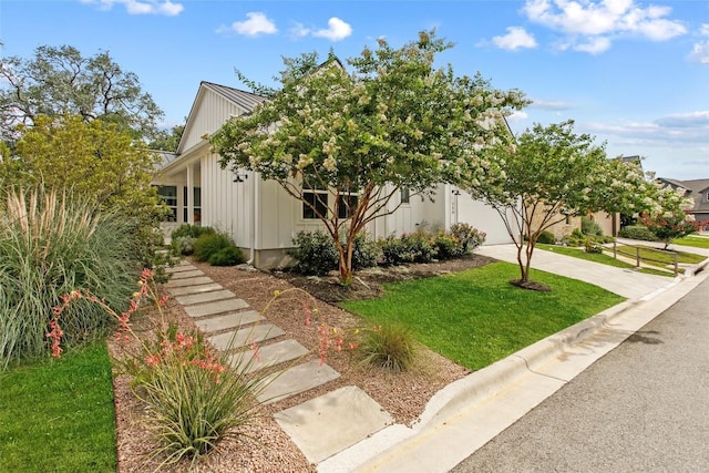 130 Volterra Ln, Dripping Springs, TX 78620 - view of front facade featuring driveway, a front yard, and an attached garage