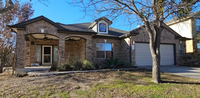 19500 Moorlynch Ave, Pflugerville, TX 78660 - view of front of property featuring concrete driveway, a garage, and brick siding
