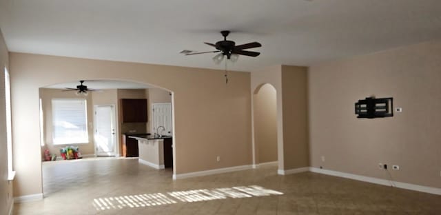 19500 Moorlynch Ave, Pflugerville, TX 78660 - unfurnished living room with ceiling fan and arched walkways