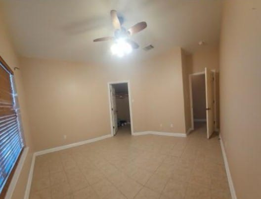 19500 Moorlynch Ave, Pflugerville, TX 78660 - empty room with a ceiling fan and baseboards