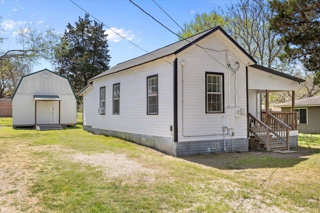 708 Baumgarten St, Schulenburg, TX 78956 - back of property featuring a lawn, a storage unit, and crawl space