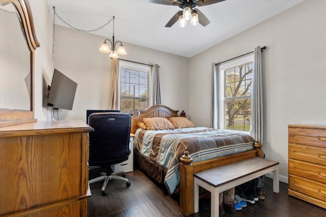 708 Baumgarten St, Schulenburg, TX 78956 - bedroom featuring multiple windows, dark wood-style floors, an office area, and a ceiling fan