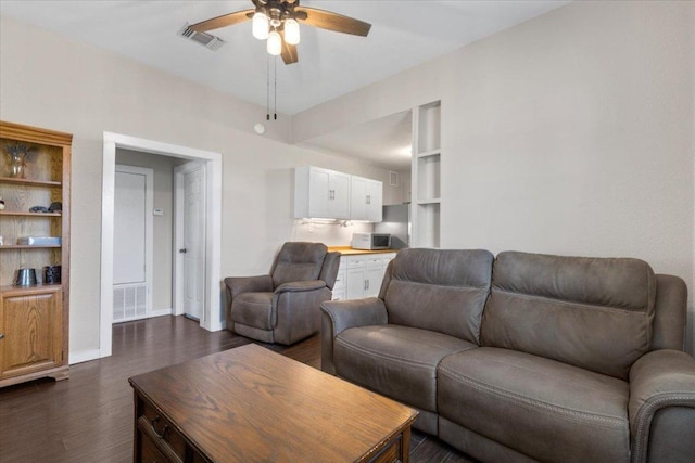 708 Baumgarten St, Schulenburg, TX 78956 - living area featuring dark wood-style floors and ceiling fan