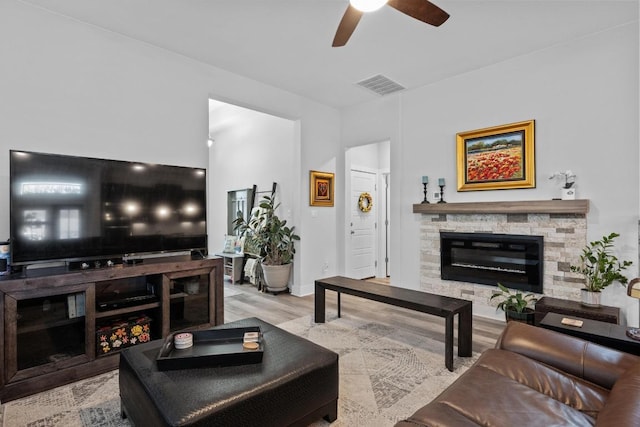 217 Palio Pl, Georgetown, TX 78628 - living room featuring ceiling fan, a fireplace, and wood finished floors
