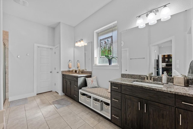 217 Palio Pl, Georgetown, TX 78628 - bathroom with a shower stall, two vanities, and tile patterned floors