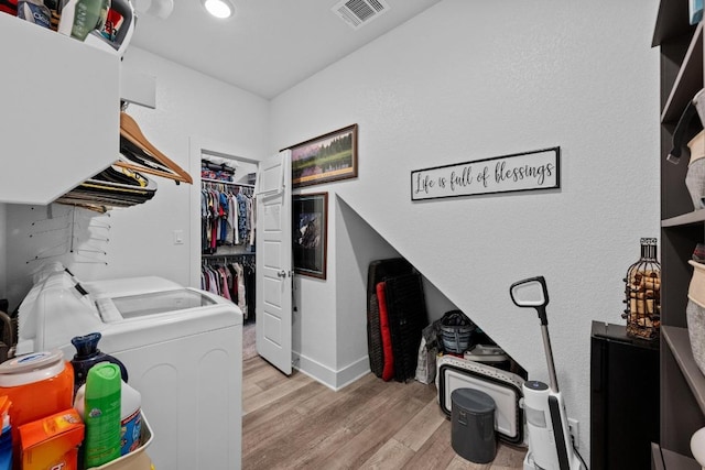 217 Palio Pl, Georgetown, TX 78628 - washroom featuring independent washer and dryer and light wood finished floors