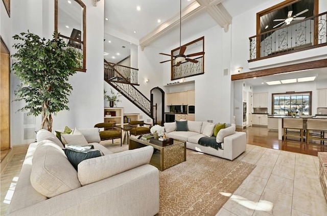 114 Flying Scot St, Lakeway, TX 78734 - living room featuring a ceiling fan, stairway, arched walkways, a towering ceiling, and recessed lighting