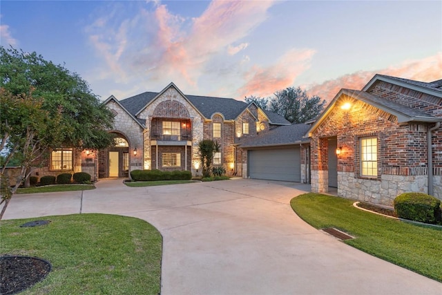 114 Flying Scot St, Lakeway, TX 78734 - french provincial home featuring stone siding, curved driveway, a yard, and a garage