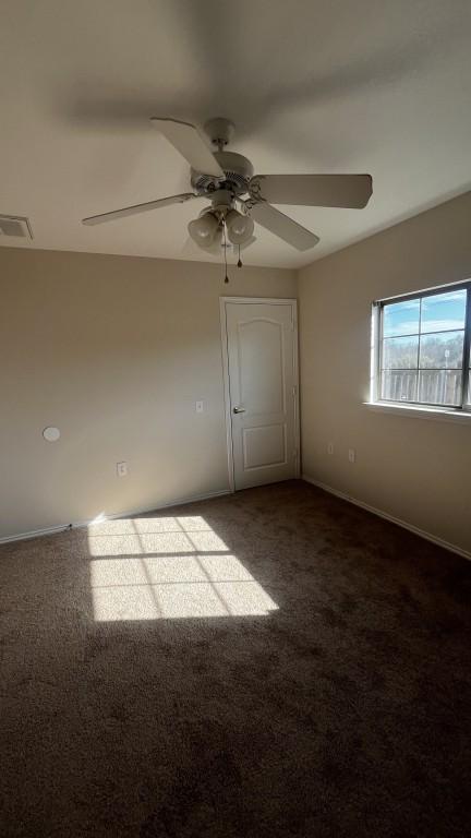 13217 Perconte Dr, Del Valle, TX 78617 - carpeted empty room with a ceiling fan and baseboards