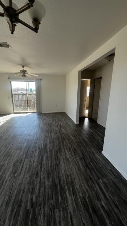 13217 Perconte Dr, Del Valle, TX 78617 - empty room with a ceiling fan and dark wood-style floors