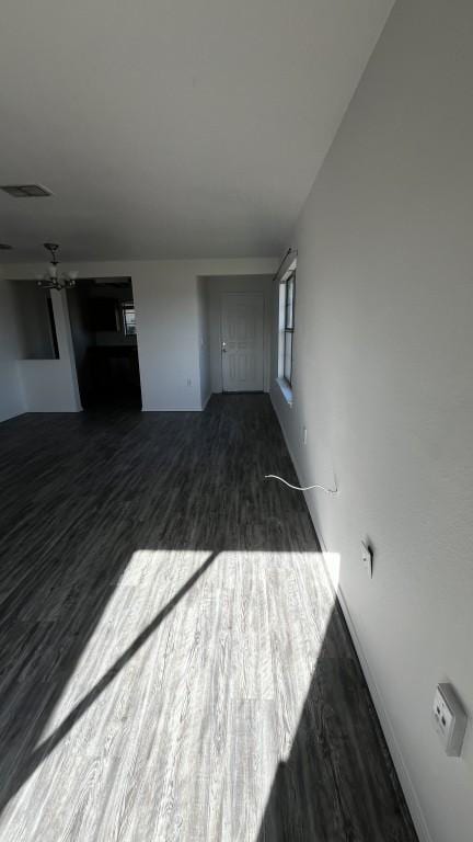 13217 Perconte Dr, Del Valle, TX 78617 - unfurnished living room with dark wood-style flooring