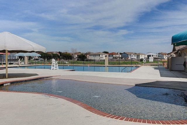 13217 Perconte Dr, Del Valle, TX 78617 - community pool featuring a patio area and a residential view