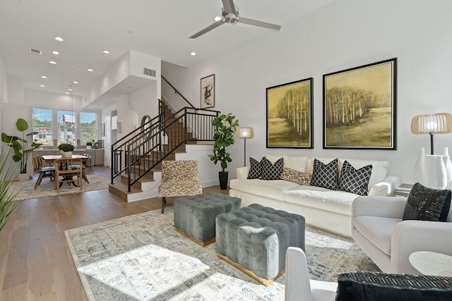 living room featuring stairs, recessed lighting, visible vents, a ceiling fan, and wood finished floors