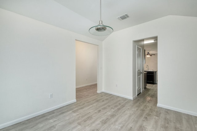 11648 Cambrian Rd, Manor, TX 78653 - unfurnished room with lofted ceiling, light wood finished floors, baseboards, a sink, and a ceiling fan