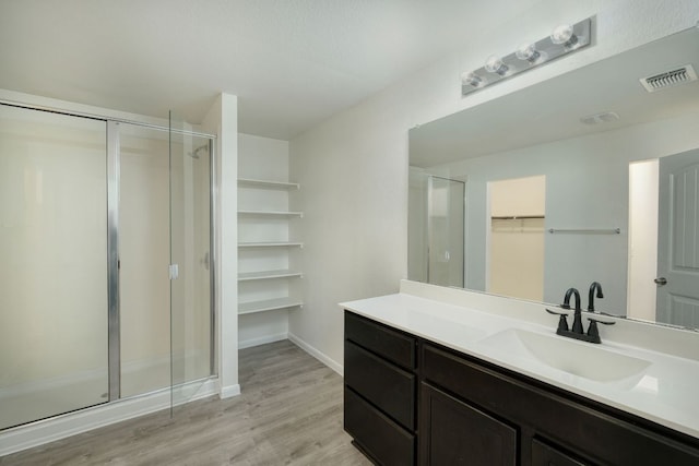 11648 Cambrian Rd, Manor, TX 78653 - bathroom with a walk in closet, a stall shower, and vanity