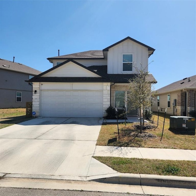traditional home featuring cooling unit, an attached garage, stone siding, board and batten siding, and driveway