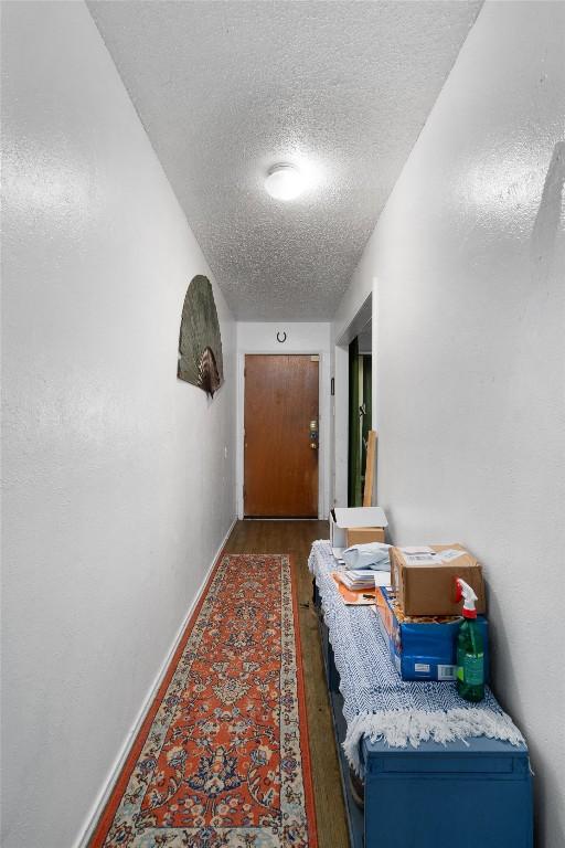 1905 Chestnut Ave, Austin, TX 78722 - hallway featuring a textured ceiling and wood finished floors