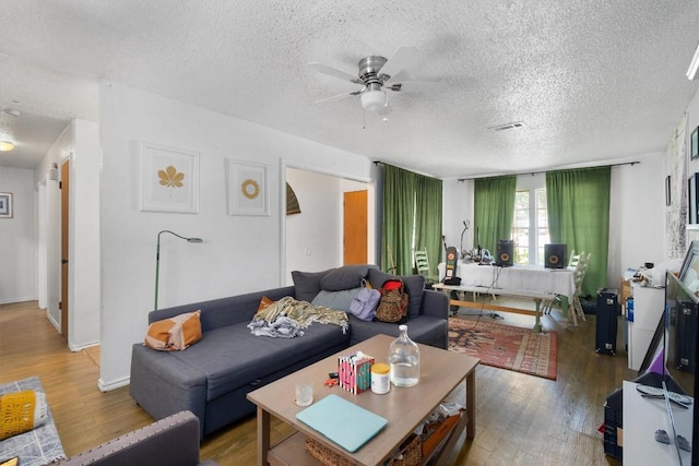 1905 Chestnut Ave, Austin, TX 78722 - living room with light wood-style flooring, a textured ceiling, and ceiling fan