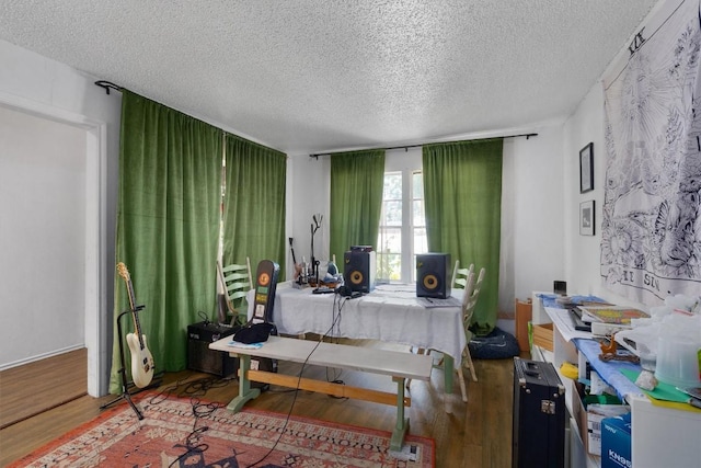 1905 Chestnut Ave, Austin, TX 78722 - bedroom featuring a textured ceiling and wood finished floors