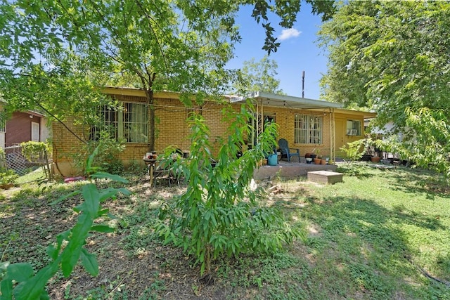 1905 Chestnut Ave, Austin, TX 78722 - rear view of property featuring brick siding and a patio