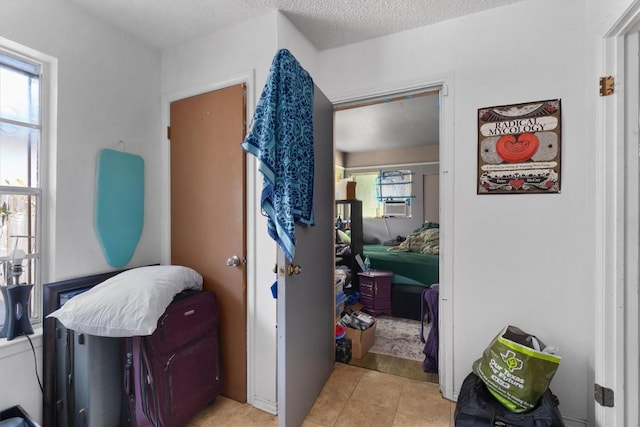1905 Chestnut Ave, Austin, TX 78722 - hallway featuring light tile patterned floors, a textured ceiling, and cooling unit