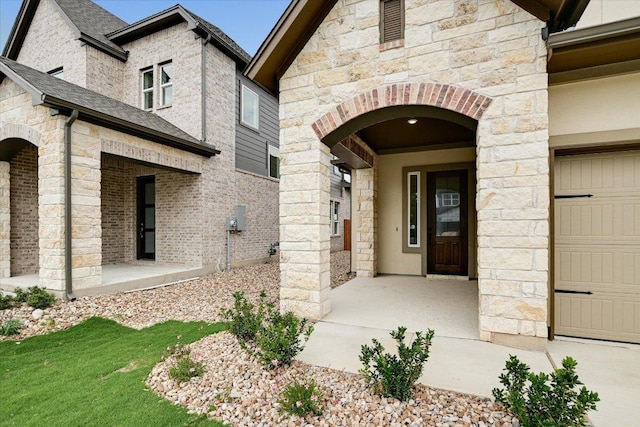 1409 S Brook Dr, Leander, TX 78641 - view of exterior entry with a garage and stone siding