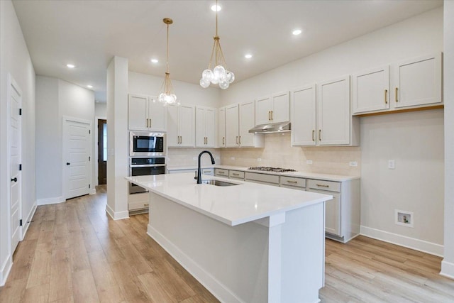 1409 S Brook Dr, Leander, TX 78641 - kitchen featuring oven, built in microwave, light wood finished floors, decorative backsplash, and recessed lighting