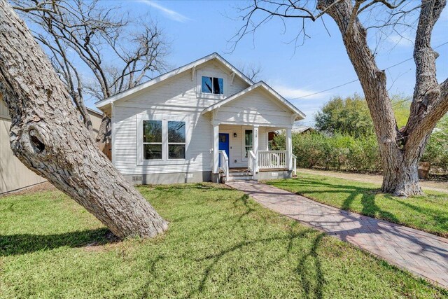 bungalow-style home featuring a porch and a front lawn