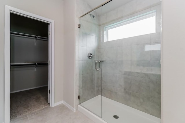 20411 Rockpark Ln, Lago Vista, TX 78645 - bathroom with a shower stall, a spacious closet, and tile patterned flooring