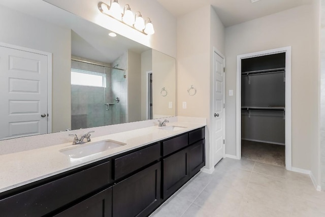 20411 Rockpark Ln, Lago Vista, TX 78645 - bathroom featuring a stall shower, double vanity, a spacious closet, and tile patterned floors