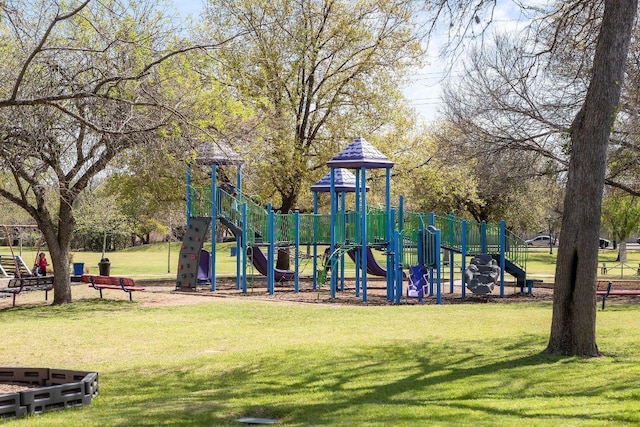 community jungle gym featuring a yard