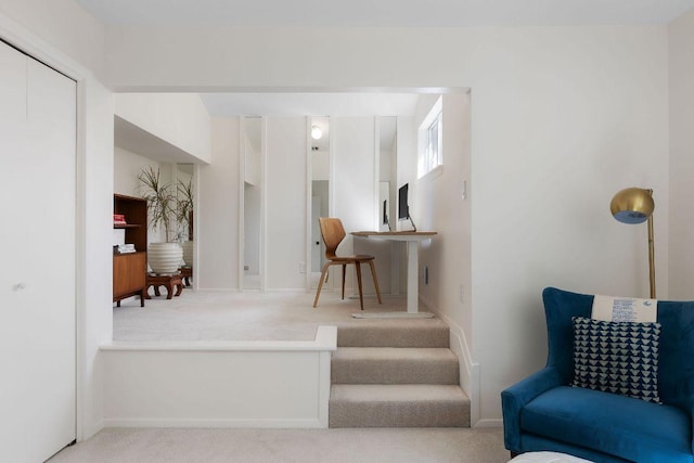 living area with baseboards and carpet