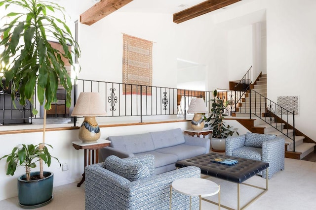living area with stairs, high vaulted ceiling, beam ceiling, and carpet