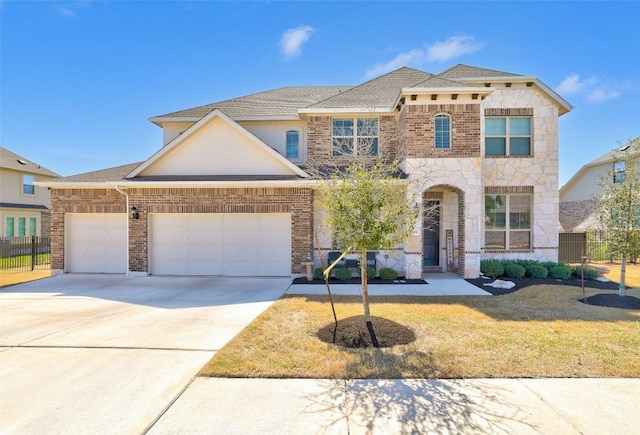 212 Tovas Secret Cv, Georgetown, TX 78628 - view of front of house featuring driveway, stone siding, an attached garage, and fence