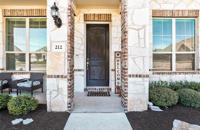 212 Tovas Secret Cv, Georgetown, TX 78628 - view of exterior entry featuring stone siding and a porch