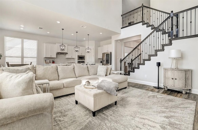 212 Tovas Secret Cv, Georgetown, TX 78628 - living room featuring baseboards, recessed lighting, wood finished floors, and stairway