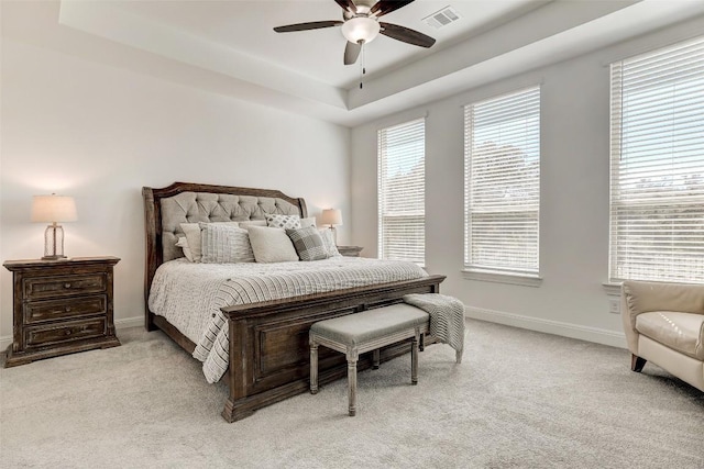 212 Tovas Secret Cv, Georgetown, TX 78628 - bedroom featuring baseboards, a raised ceiling, visible vents, a ceiling fan, and light carpet