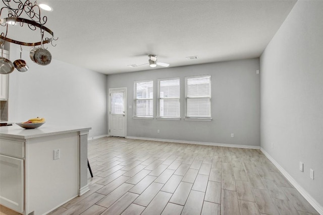 1813 Artesian Springs Xing, Leander, TX 78641 - unfurnished living room with ceiling fan, light wood-type flooring, and a chandelier