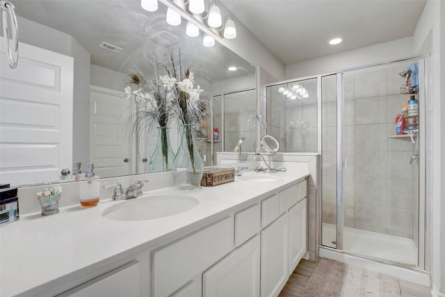 1813 Artesian Springs Xing, Leander, TX 78641 - full bath with double vanity, a shower stall, wood finished floors, and recessed lighting