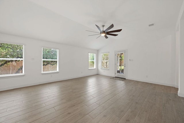 21203 Santa Rosa Ave, Lago Vista, TX 78645 - empty room featuring plenty of natural light, ceiling fan, wood finished floors, and vaulted ceiling